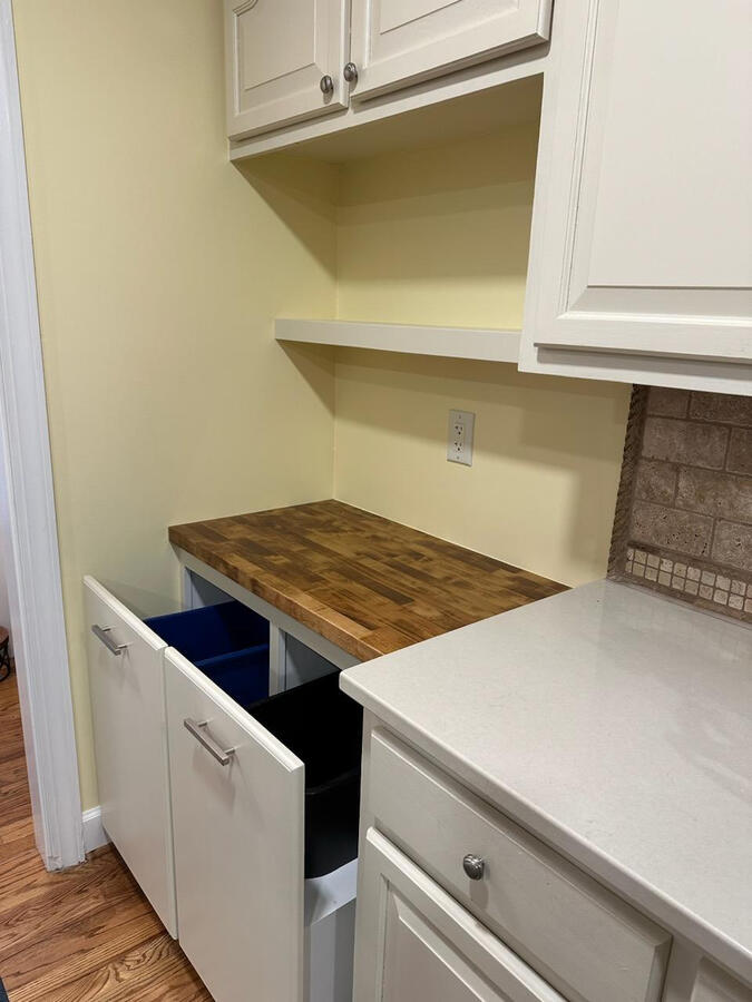 Jesse custom-built this soft close trash cabinet and finished it with a butcher block top.
